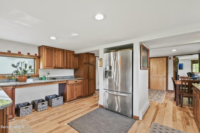 288 Johnson Rd, Dalton, MA 01226 - kitchen featuring stainless steel fridge with ice dispenser, light wood-style flooring, brown cabinets, light stone countertops, and recessed lighting