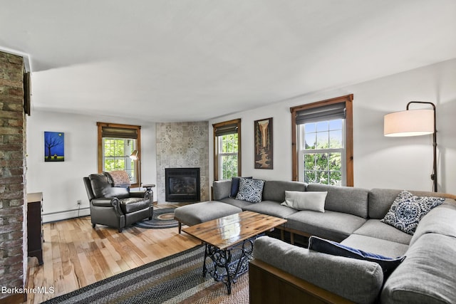 288 Johnson Rd, Dalton, MA 01226 - living room featuring a baseboard radiator, a tiled fireplace, and hardwood / wood-style floors
