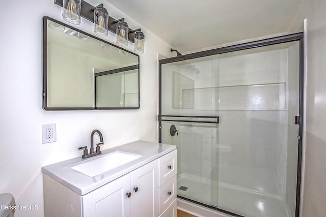 bathroom featuring vanity and an enclosed shower