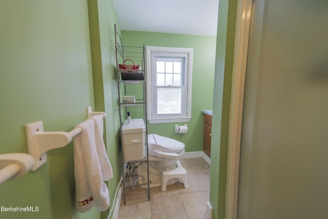 bathroom featuring tile patterned floors, vanity, and toilet