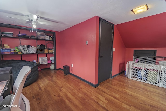 bedroom featuring ceiling fan, wood-type flooring, and vaulted ceiling