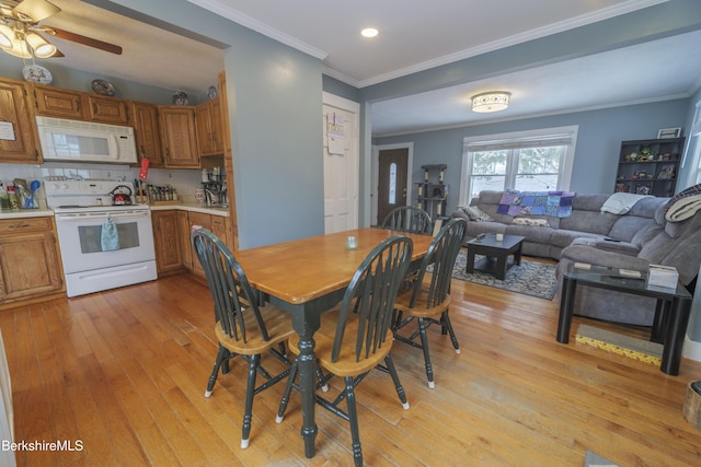 dining room with ceiling fan, light hardwood / wood-style floors, and ornamental molding