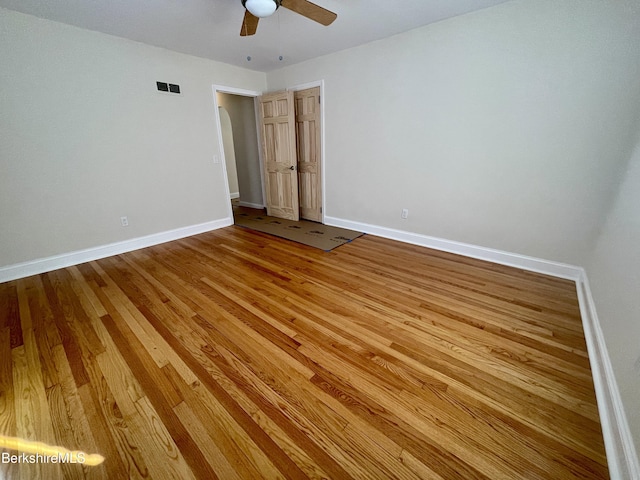 unfurnished bedroom with ceiling fan and hardwood / wood-style flooring