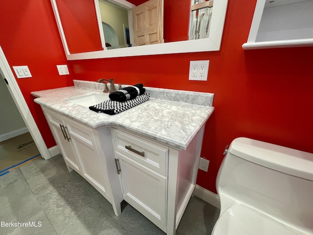 bathroom featuring toilet and vanity