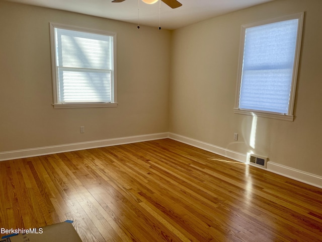 unfurnished room with wood-type flooring and ceiling fan