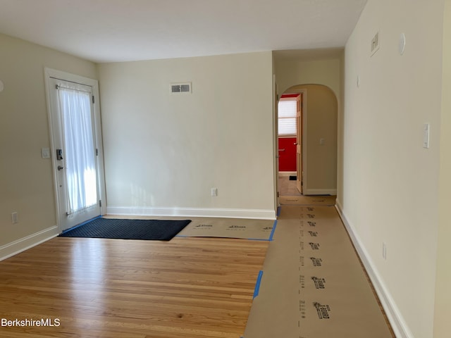 unfurnished room featuring hardwood / wood-style floors and a wealth of natural light