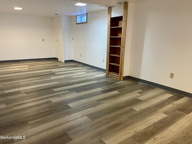 unfurnished room with dark wood-type flooring