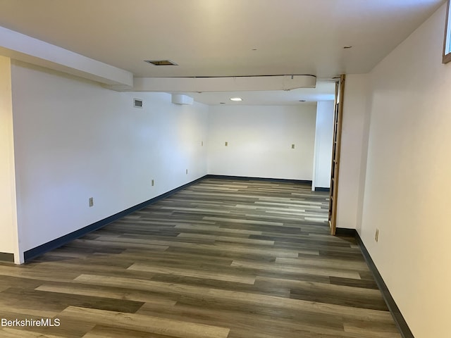 basement featuring dark hardwood / wood-style flooring