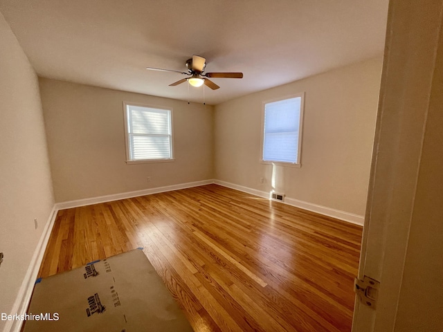 unfurnished room with hardwood / wood-style floors and ceiling fan