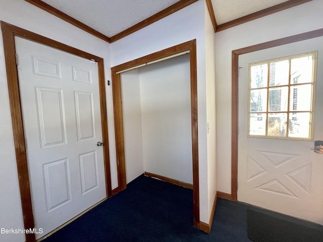 doorway to outside with ornamental molding and dark carpet