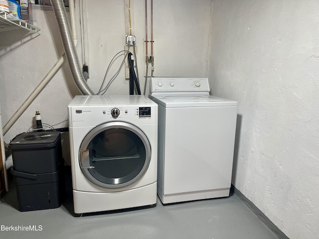 clothes washing area featuring washer and dryer