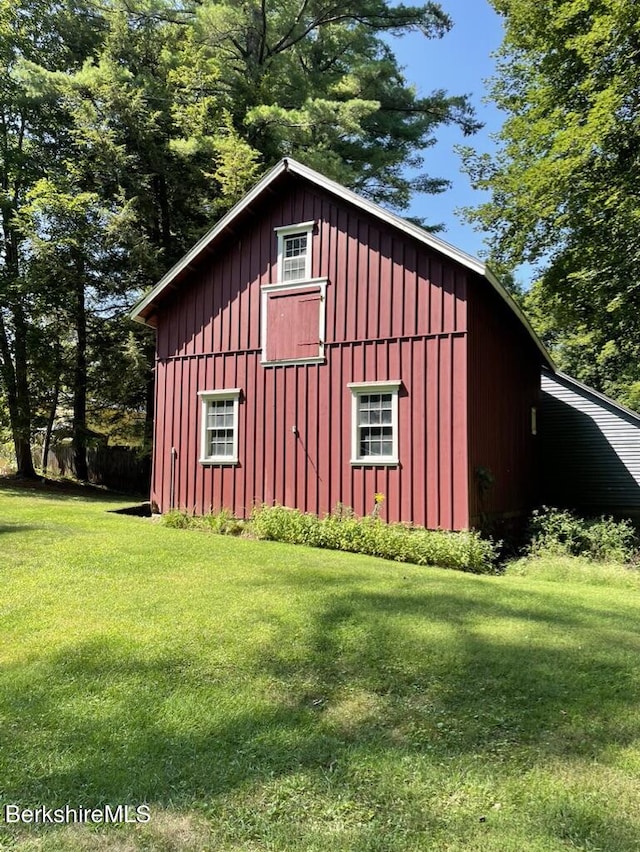 view of outdoor structure featuring a lawn