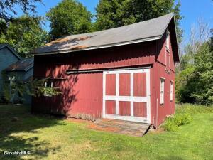 view of outbuilding featuring a lawn