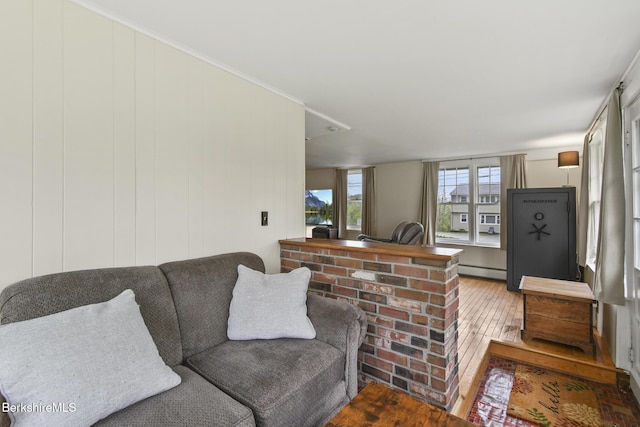 living area featuring hardwood / wood-style floors and baseboard heating
