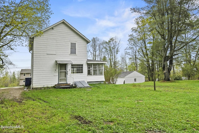 rear view of house with a yard