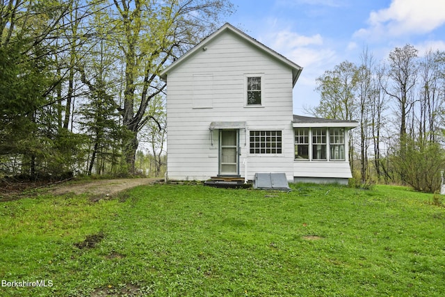 back of property with a yard