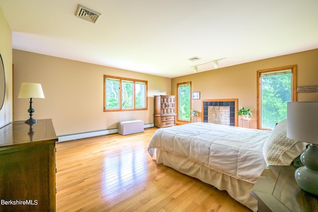 26 Filomena Dr, Pittsfield, MA 01201 - bedroom with baseboard heating, wood finished floors, and track lighting