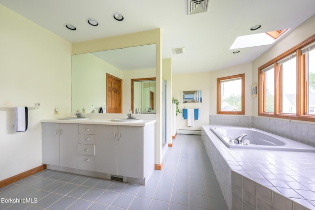 26 Filomena Dr, Pittsfield, MA 01201 - bathroom featuring double vanity, a skylight, a garden tub, a baseboard radiator, and healthy amount of natural light