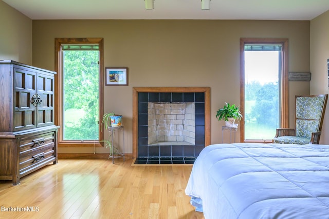 26 Filomena Dr, Pittsfield, MA 01201 - bedroom with wood finished floors, multiple windows, and a tiled fireplace