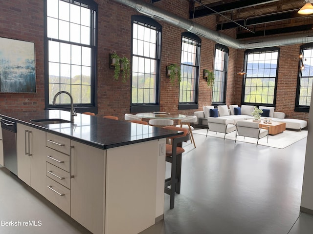 160 Water St Unit 407, Williamstown, MA 01267 - kitchen with a towering ceiling, brick wall, a sink, dishwasher, and finished concrete floors