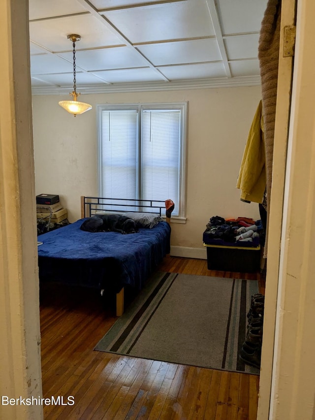 bedroom with coffered ceiling and hardwood / wood-style floors