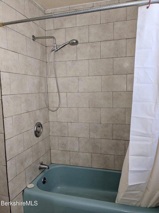 bathroom featuring shower / tub combo with curtain