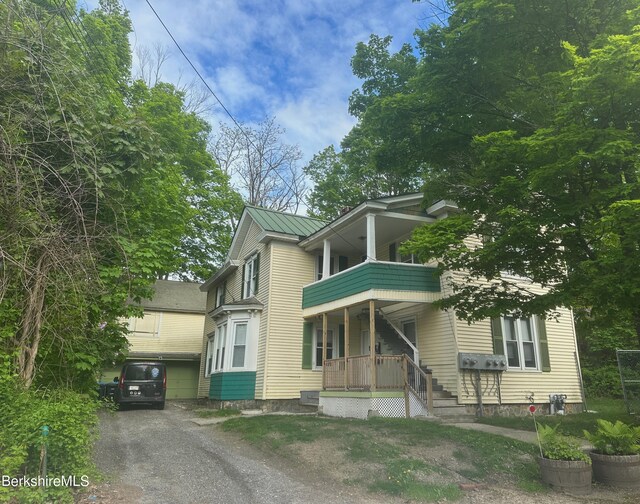 21 Goodrich St, Pittsfield, MA 01201 - view of front facade featuring a porch, a balcony, a garage, and driveway