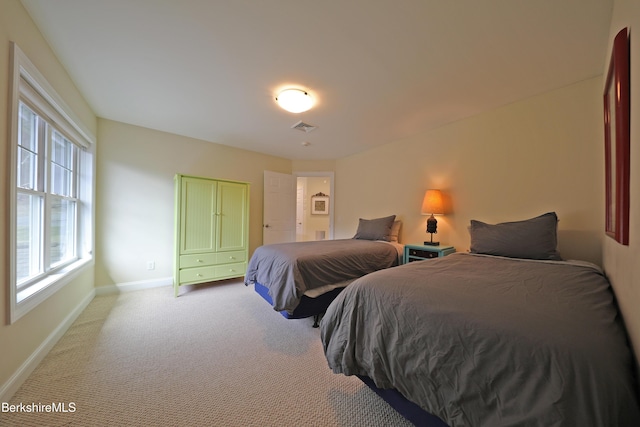 bedroom with visible vents, carpet flooring, baseboards, and multiple windows