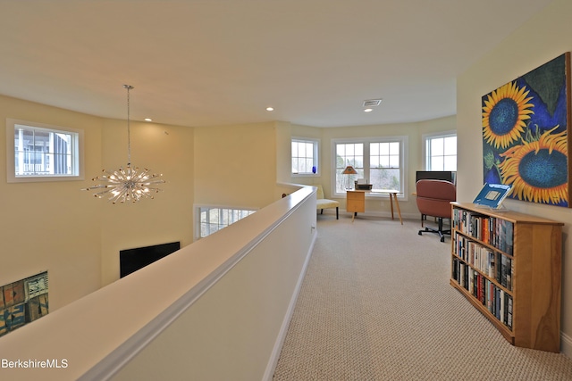 hallway featuring visible vents, baseboards, an inviting chandelier, recessed lighting, and light colored carpet