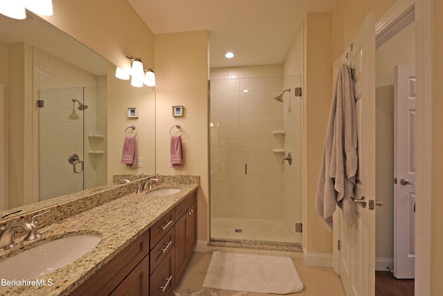 bathroom featuring a shower stall and a sink
