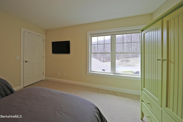 carpeted bedroom with baseboards