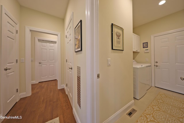 hall featuring baseboards, washing machine and clothes dryer, light wood-type flooring, and recessed lighting
