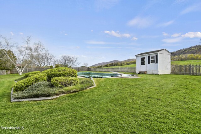 75 E Rd, Adams, MA 01220 - view of yard featuring a storage shed, an outbuilding, a fenced in pool, and a fenced backyard