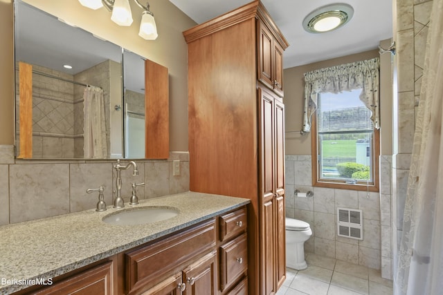 75 E Rd, Adams, MA 01220 - full bathroom with tile walls, toilet, wainscoting, tile patterned flooring, and vanity