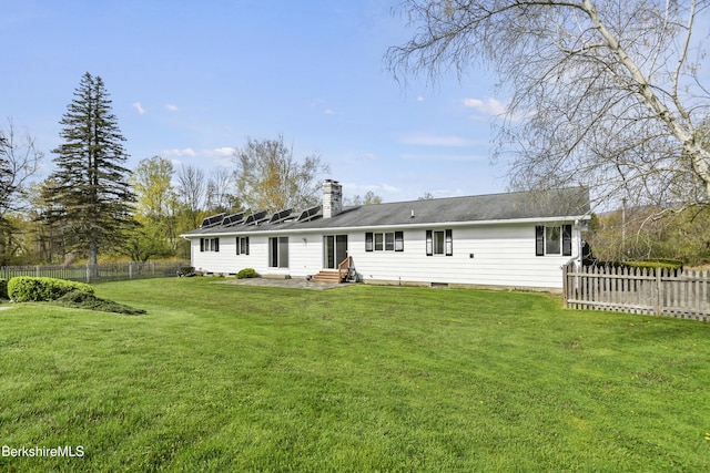 75 E Rd, Adams, MA 01220 - rear view of property featuring a lawn, a fenced backyard, a chimney, and entry steps