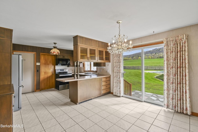 75 E Rd, Adams, MA 01220 - kitchen with a peninsula, appliances with stainless steel finishes, a chandelier, and a healthy amount of sunlight