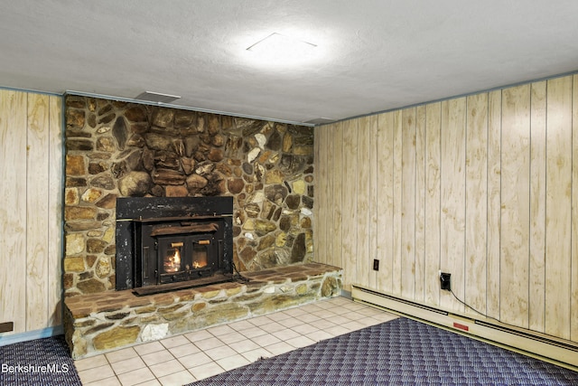 75 E Rd, Adams, MA 01220 - interior space with a baseboard radiator, tile patterned floors, wooden walls, and a fireplace