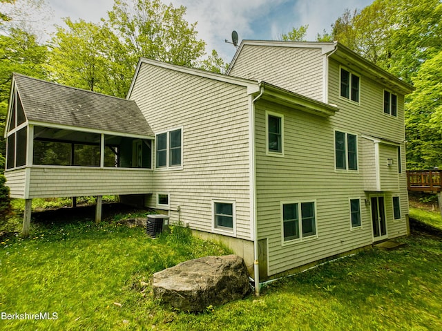 232 Harrington Rd, Otis, MA 01253 - rear view of house featuring a sunroom, central air condition unit, and a yard
