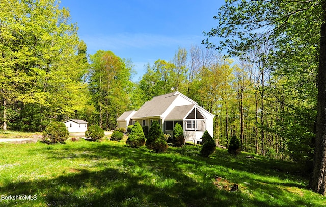232 Harrington Rd, Otis, MA 01253 - view of side of home featuring a yard and a wooded view