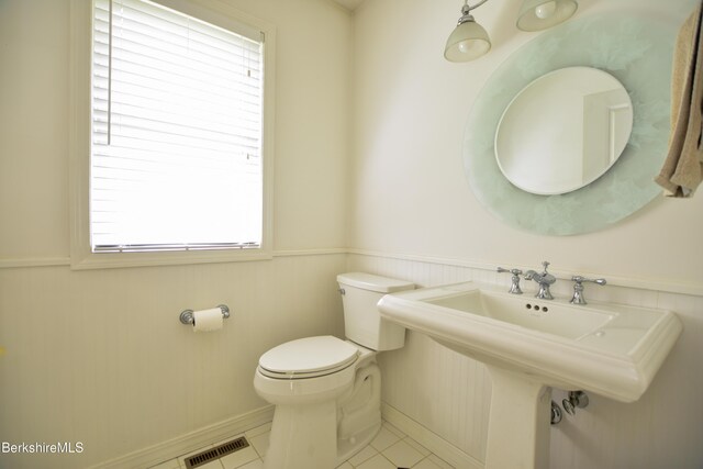 232 Harrington Rd, Otis, MA 01253 - bathroom featuring a wainscoted wall, toilet, a sink, tile patterned flooring, and baseboards