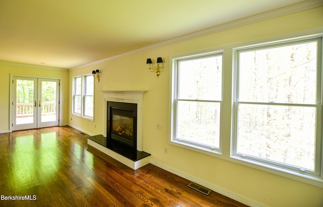 232 Harrington Rd, Otis, MA 01253 - unfurnished living room featuring baseboards, crown molding, a glass covered fireplace, dark wood finished floors, and french doors