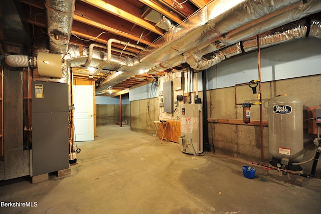 232 Harrington Rd, Otis, MA 01253 - unfinished below grade area with water heater, a water pressure tank, and electric panel