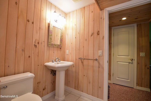 232 Harrington Rd, Otis, MA 01253 - bathroom featuring wooden walls, toilet, a sink, and baseboards