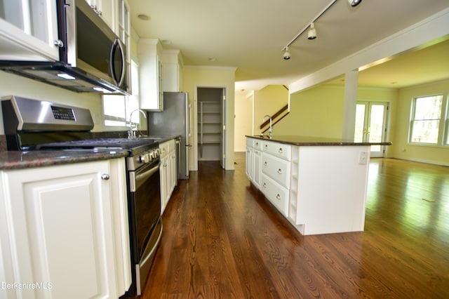 232 Harrington Rd, Otis, MA 01253 - kitchen with appliances with stainless steel finishes, dark countertops, white cabinetry, and dark wood finished floors
