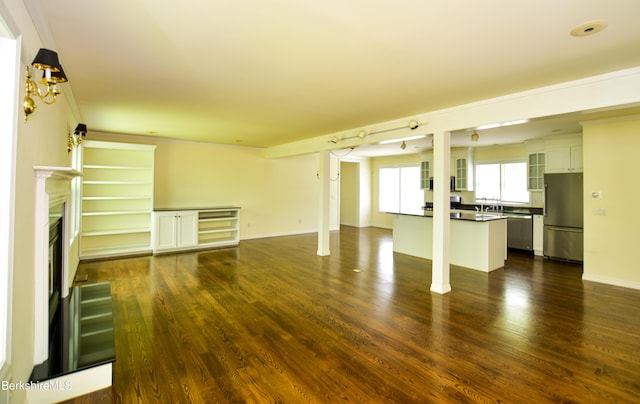 232 Harrington Rd, Otis, MA 01253 - unfurnished living room featuring dark wood-style floors, a glass covered fireplace, and baseboards