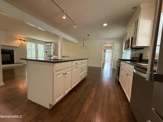 232 Harrington Rd, Otis, MA 01253 - kitchen with dark countertops, a sink, stainless steel appliances, white cabinets, and recessed lighting