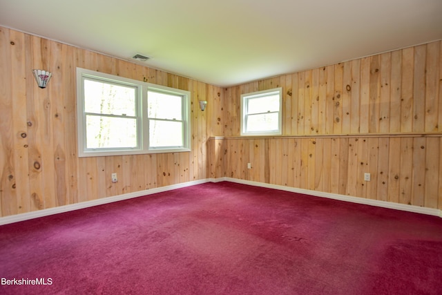 232 Harrington Rd, Otis, MA 01253 - carpeted empty room featuring wood walls and baseboards