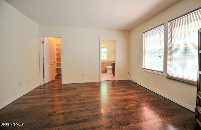 232 Harrington Rd, Otis, MA 01253 - unfurnished bedroom with dark wood-style floors, a spacious closet, baseboards, and ensuite bathroom