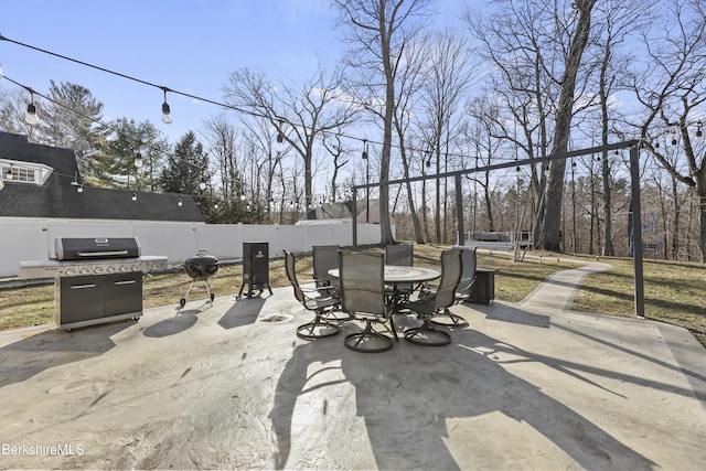 view of patio / terrace with outdoor dining space, area for grilling, and fence