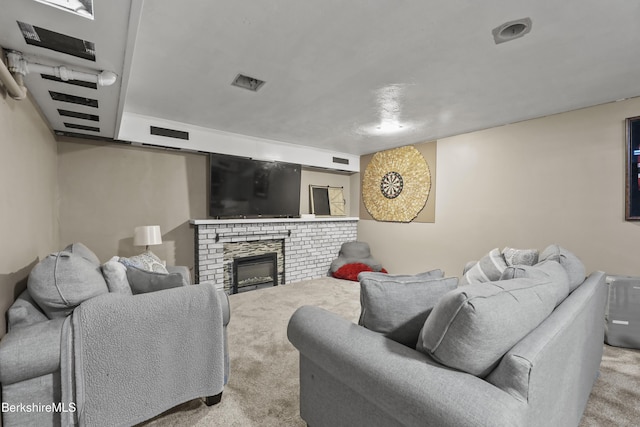 carpeted living area with visible vents and a fireplace